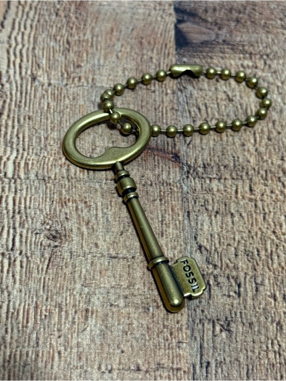 Fossil bronze key bag charm